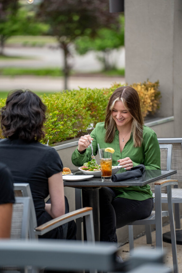 Capital Prime guest enjoying a delicious lunch on the outdoor patio