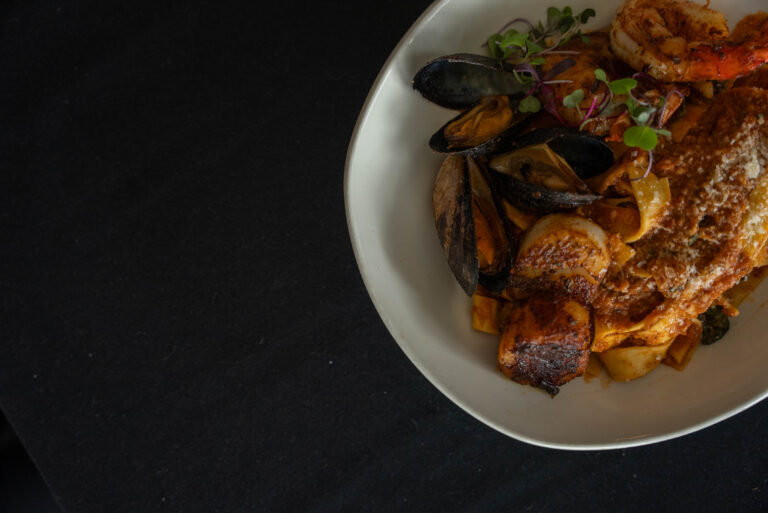 Plated seafood dinner with claims and shrimp
